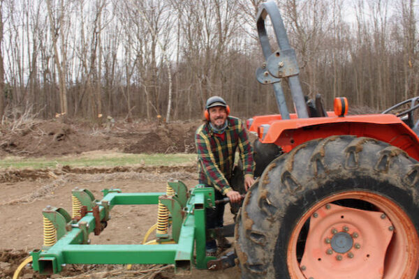 Matt tracy on tractor at Urban Edge Farm
