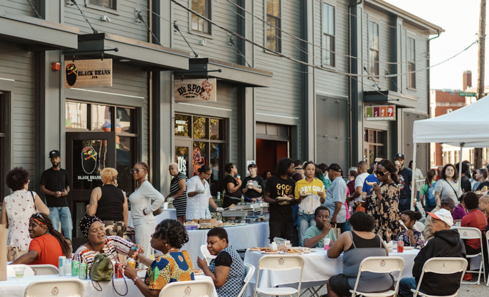Neighbors gather at SCLT's Block Party on October 28, 2023, to celebrate the three new food businesses that are making their homes at 404 Broad Street.